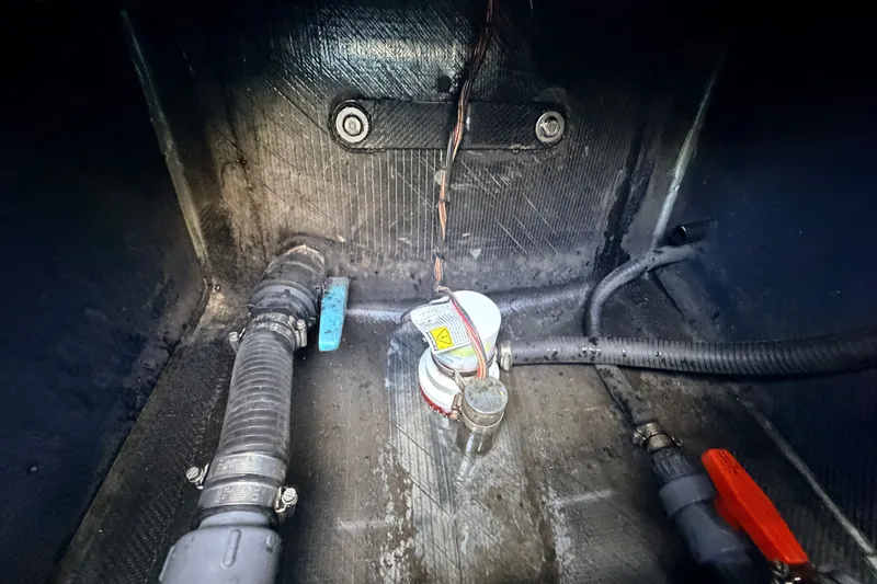 Slide: The Image of Bilge area of a 2021 Chittum Skiffs Islamorada 21, showing hoses and wiring. - 76