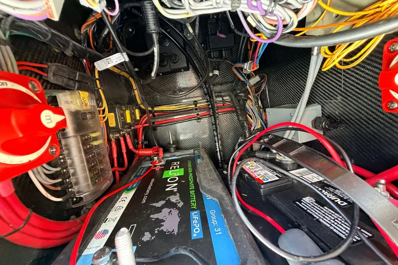 Slide: The Image of Electrical wiring and battery setup inside a 2021 Chittum Skiffs Islamorada 21 boat. - 51