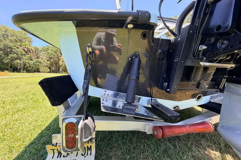 Slide: The Image of 2021 Chittum Skiffs Islamorada 21 boat trailer detail with grass background. - 15