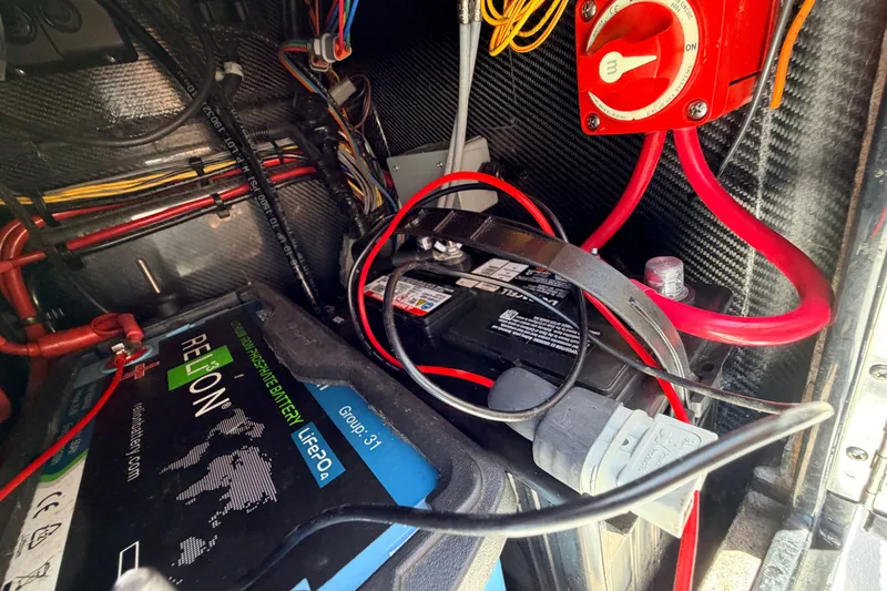 Slide: The Image of 2021 Chittum Skiffs Islamorada 21 battery compartment with wiring and power switch. - 50