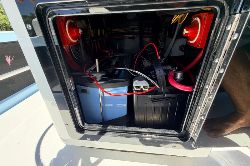 Slide: The Image of Battery compartment of 2021 Chittum Skiffs Islamorada 21, showing wiring and connections. - 48