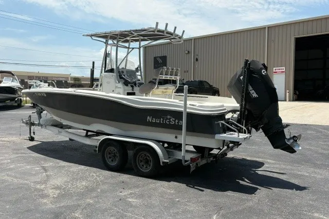 Slide: The Image of 2017 NauticStar 231 Coastal boat on trailer, parked outside a warehouse. - 4