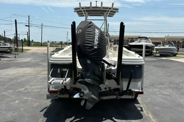 Slide: The Image of 2017 NauticStar 231 Coastal boat with Evinrude outboard motor, rear view in marina. - 3