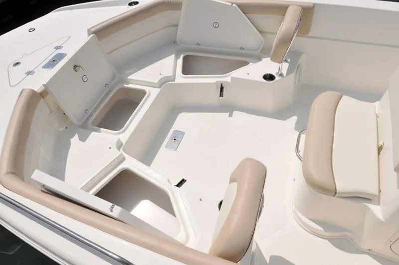 Slide: The Image of Manufacturer Provided Image: 2017 NauticStar 231 Coastal boat interior with beige seating and storage compartments. - 11