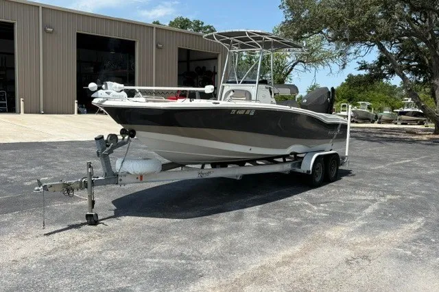 Slide: The Image of 2017 NauticStar 231 Coastal boat on trailer, parked outside a warehouse. - 6