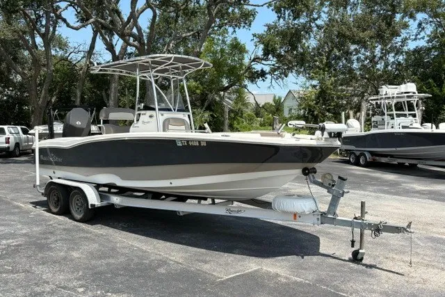 Slide: The Image of 2017 NauticStar 231 Coastal boat on trailer in parking lot. - 0