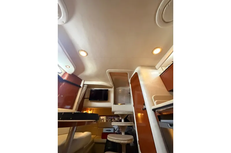 Slide: The Image of Interior of 2004 Sea Ray Sundancer 320 yacht, featuring elegant wood finishes and modern amenities. - 16