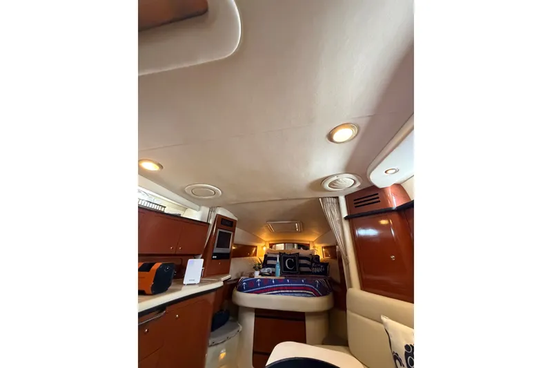 Slide: The Image of Interior of 2004 Sea Ray Sundancer 320 yacht, featuring cozy cabin and elegant wood finishes. - 20