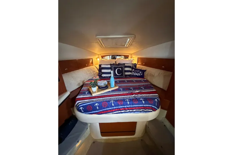 Slide: The Image of Cozy cabin interior of 2004 Sea Ray Sundancer 320 with nautical-themed bedding. - 21