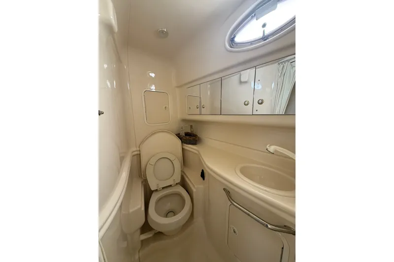 Slide: The Image of Bathroom interior of 2004 Sea Ray Sundancer 320 yacht, featuring toilet and sink. - 25