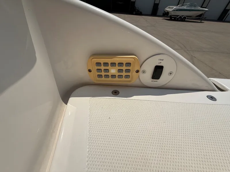 Slide: The Image of Close-up of a boat deck with control buttons and trim control. - 23