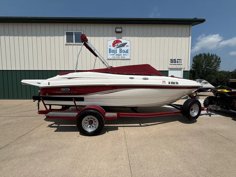 Slide: The Image of A white and red 2005 Chaparral 190 SSi boat on a trailer in front of a building. - 26