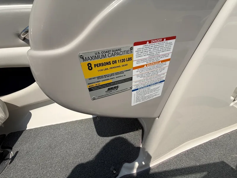 Slide: The Image of Close-up of a boat plaque showing capacity information for 8 persons or 1120 pounds. - 21