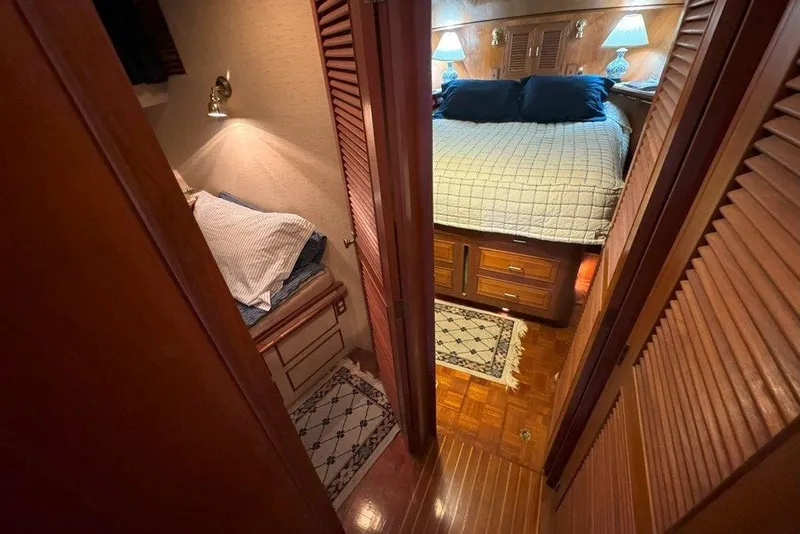 Slide: The Image of Cozy cabin interior of 1983 Ocean Alexander 40 Europa yacht with wooden finishes and bedding. - 17