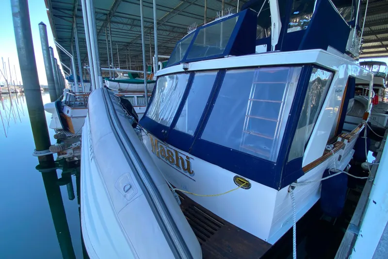 Slide: The Image of 1983 Ocean Alexander 40 Europa yacht docked with inflatable boat alongside. - 54