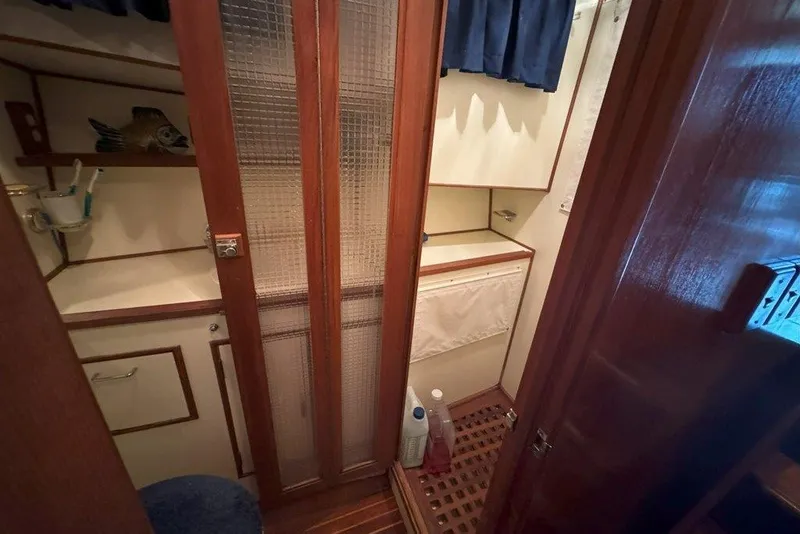 Slide: The Image of 1983 Ocean Alexander 40 Europa yacht interior with wooden cabinetry and storage space. - 21
