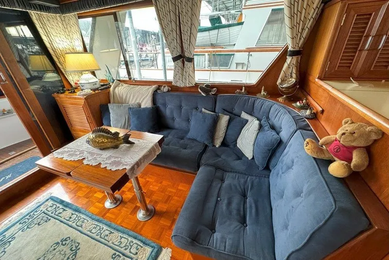 Slide: The Image of Cozy interior of 1983 Ocean Alexander 40 Europa yacht with blue seating and decorative items. - 5