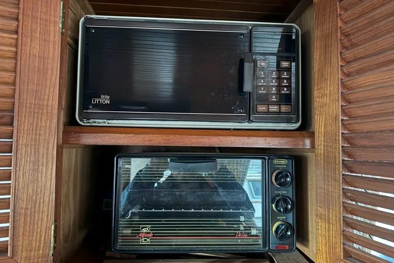 Slide: The Image of Vintage microwave and toaster oven in wooden cabinet on 1983 Ocean Alexander 40 Europa. - 27