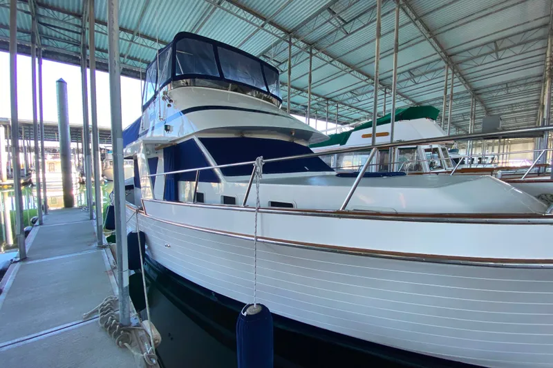 Slide: The Image of 1983 Ocean Alexander 40 Europa yacht docked in a covered marina. - 49