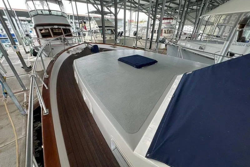 Slide: The Image of 1983 Ocean Alexander 40 Europa yacht docked in a marina, showcasing its deck and railing. - 31