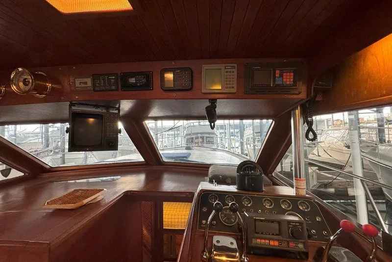 Slide: The Image of 1983 Ocean Alexander 40 Europa yacht interior with navigation instruments and helm controls. - 15