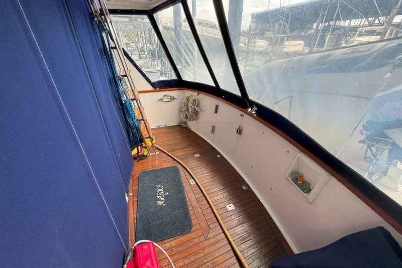 Slide: The Image of 1983 Ocean Alexander 40 Europa yacht deck with wooden flooring and blue canvas cover. - 28