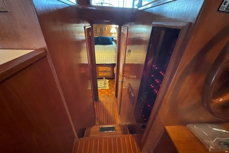 Slide: The Image of Interior view of 1983 Ocean Alexander 40 Europa yacht, featuring wooden paneling and cozy cabin. - 16
