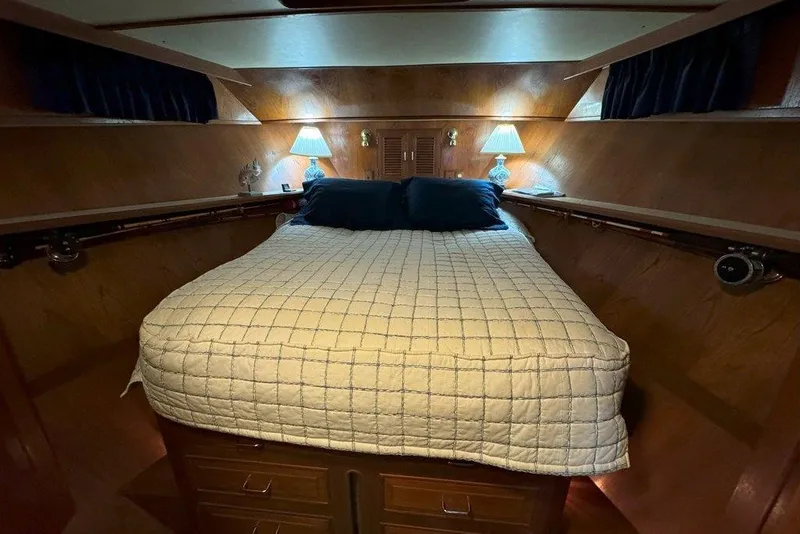 Slide: The Image of Cozy cabin interior of 1983 Ocean Alexander 40 Europa with bed and ambient lighting. - 23