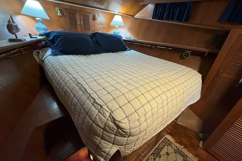 Slide: The Image of Cozy cabin bedroom in 1983 Ocean Alexander 40 Europa yacht with quilted bedding and warm lighting. - 24