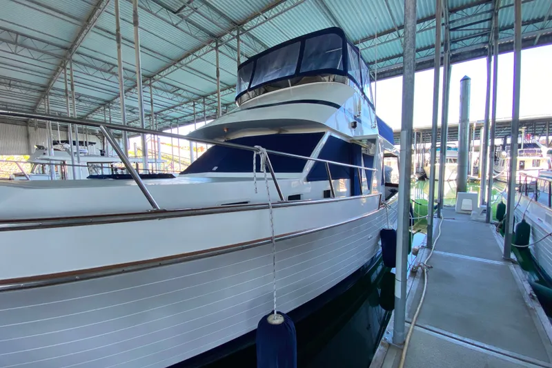 Slide: The Image of 1983 Ocean Alexander 40 Europa yacht docked in a covered marina. - 51