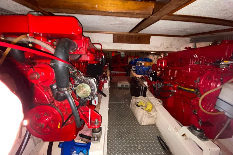 Slide: The Image of Engine room of a 1983 Ocean Alexander 40 Europa yacht with red machinery. - 57