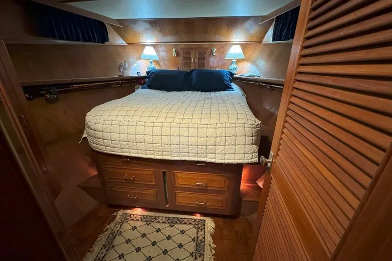 Slide: The Image of Cozy cabin interior of 1983 Ocean Alexander 40 Europa yacht with bed and warm lighting. - 22