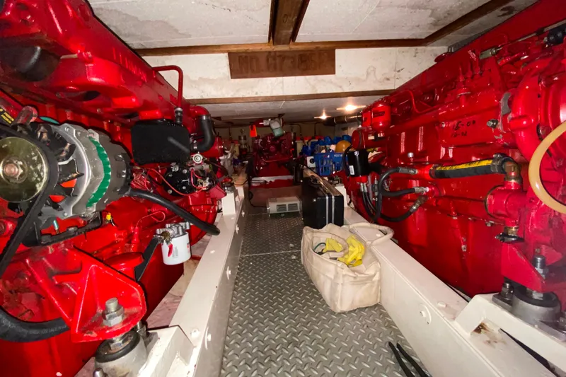 Slide: The Image of Engine room of 1983 Ocean Alexander 40 Europa yacht with red machinery and equipment. - 58