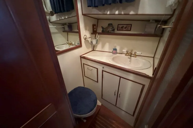 Slide: The Image of 1983 Ocean Alexander 40 Europa bathroom with sink, mirror, and wooden cabinetry. - 20