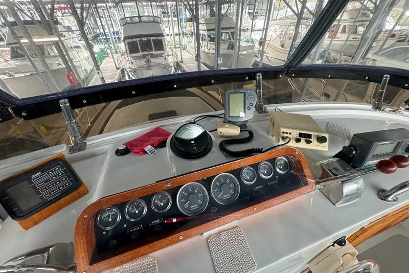 Slide: The Image of Helm of 1983 Ocean Alexander 40 Europa yacht with navigation instruments and controls. - 43