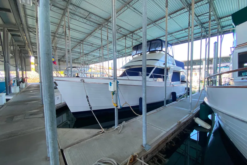 Slide: The Image of 1983 Ocean Alexander 40 Europa yacht docked in a covered marina. - 50