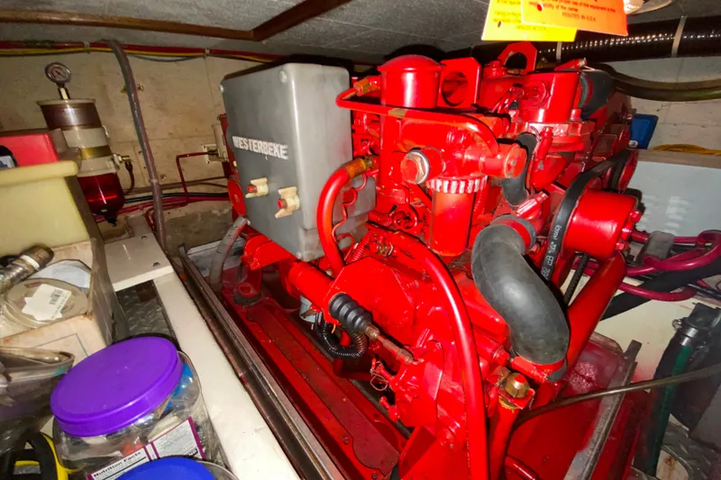 Slide: The Image of Engine room of 1983 Ocean Alexander 40 Europa with red Westerbeke generator. - 62