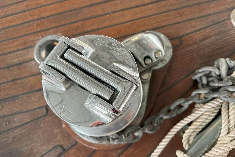 Slide: The Image of Chrome winch on 1983 Ocean Alexander 40 Europa yacht deck with chain and rope. - 33