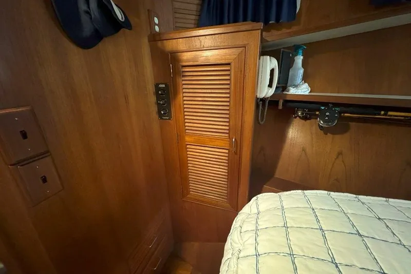 Slide: The Image of Interior of 1983 Ocean Alexander 40 Europa yacht with wooden cabinetry and cozy bedding. - 26
