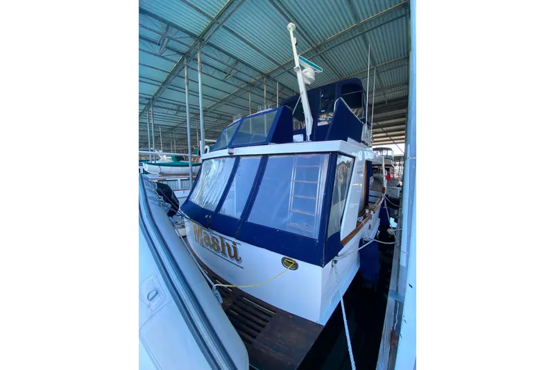 Slide: The Image of 1983 Ocean Alexander 40 Europa yacht docked in a covered marina. - 55