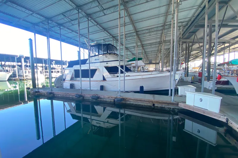 Slide: The Image of 1983 Ocean Alexander 40 Europa yacht docked in a covered marina. - 46