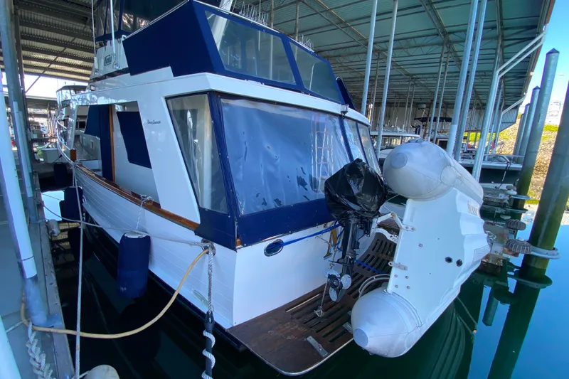 Slide: The Image of 1983 Ocean Alexander 40 Europa yacht docked with inflatable boat attached. - 53