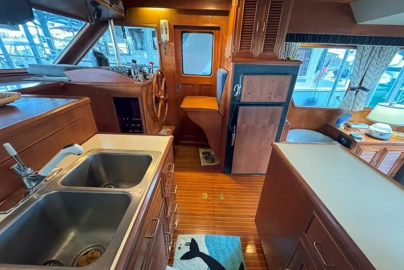 Slide: The Image of Interior of 1983 Ocean Alexander 40 Europa yacht with wooden cabinetry and dual sinks. - 12