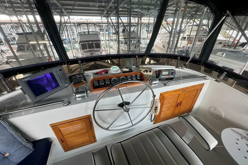 Slide: The Image of Cockpit of 1983 Ocean Alexander 40 Europa yacht with steering wheel and navigation equipment. - 41