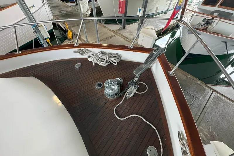 Slide: The Image of 1983 Ocean Alexander 40 Europa yacht deck with anchor and ropes in marina. - 32
