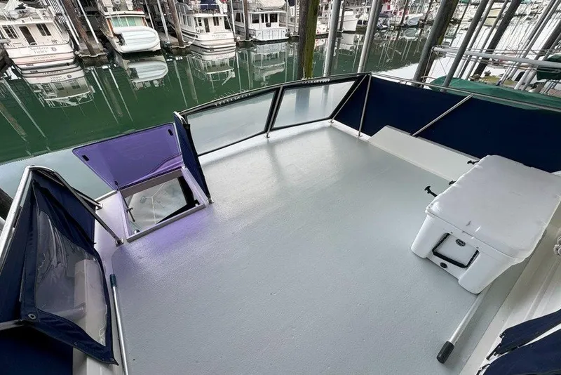 Slide: The Image of 1983 Ocean Alexander 40 Europa yacht deck with seating, docked in marina. - 39