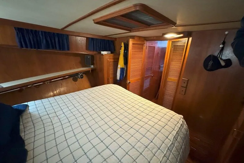 Slide: The Image of Cozy cabin interior of 1983 Ocean Alexander 40 Europa yacht with wood paneling and bed. - 25
