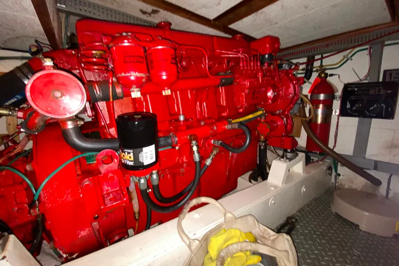 Slide: The Image of Engine room of 1983 Ocean Alexander 40 Europa with red machinery and equipment. - 63