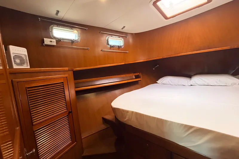 Slide: The Image of Cozy cabin interior of 2005 North Pacific 42 yacht with wooden finish and comfortable bed. - 33