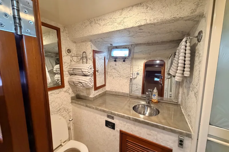 Slide: The Image of Bathroom interior of 2005 North Pacific 42 yacht with sink, mirror, and towels. - 39